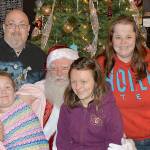 DAN HAMMOCK | GRAYS HARBOR NEWS GROUP                                Steven Beardslee and Michelle Teller flank Grays Harbor Santa inside the 7th Street Theatre Saturday. On Santas lap are Aurora Beardslee, left, and Tandra Teller. Dozens of kids told Santa what they wanted for Christmas from 5-6 p.m. at the Ho Ho Hoquiam celebration.