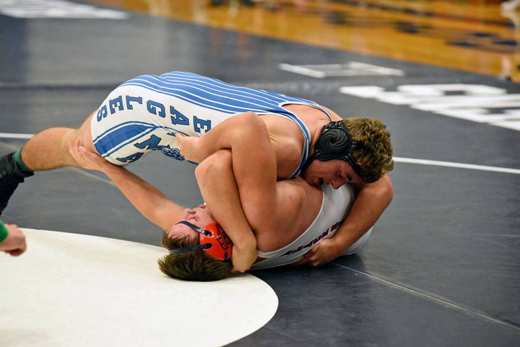 Elmas Jacob Garcia, top, pins Black HIlls Jordan Clairbridge to win the 220-pound final of the Kickoff Classic at Aberdeen High School on Saturday. (Photo by Sue Michalak)