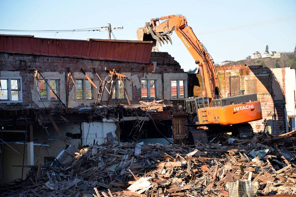 (Louis Krauss | Grays Harbor News Group)                                An excavator prepares to break off part of the old Selmers building in Aberdeen on Tuesday.