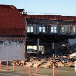 Louis Krauss | Grays Harbor News Group                                Demolition of the Selmers building continued on Tuesday after the adjacent Pourhouse structure came down Monday. The City of Aberdeen plans to save some of the bricks for construction of the Gateway Center.