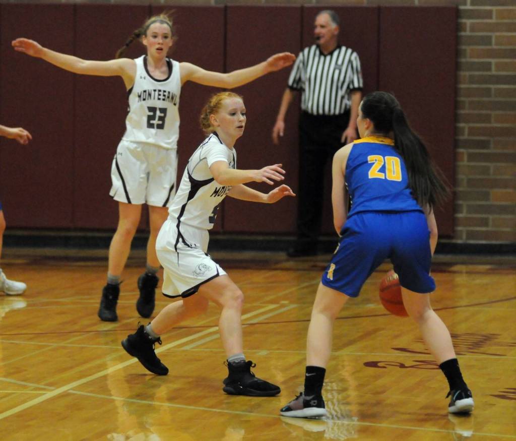 Montesano senior guard Glory Grubb, middle, defends Rochesters Lexi Jones-Sederberg during the Bulldogs 64-60 overtime loss on Tuesday in Montesano. (Ryan Sparks | Grays Harbor News Group)