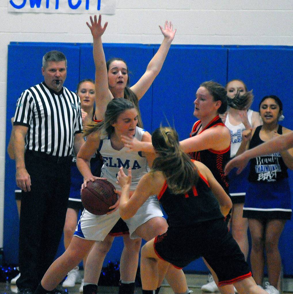 Elmas Jalyn Sackrider deals with a triple team in the post during the third quarter against Centralia on Wednesday. Sackrider put up 15 points and grabbed 11 boards in the game. (Hasani Grayson | Grays Harbor News Group)