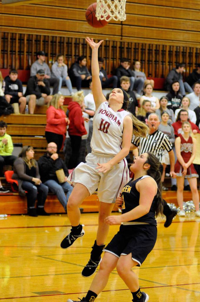 Hoquiam sophomore Sharaya Brydon attempts a layup against Aberdeens Ryder Heikkila during the Grizzlies 48-38 win on Thursday at Hoquiam High School. (Ryan Sparks | Grays Harbor News Group)