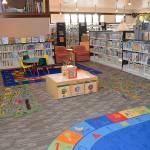 Photos by DAN HAMMOCK | GRAYS HARBOR NEWS GROUP                                 ABOVE: The childrens area of the Hoquiam Timberland Library is colorful and airy.                                RIGHT: Laurie Enholm arranges a piece of carpeting at the library on Friday morning.
