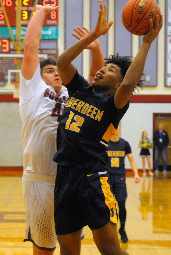 Aberdeens Derrell Shale goes up for close-range shot while Hoquiams Matt Brown defends on Friday. (Hasani Grayson | Grays Harbor News Group)