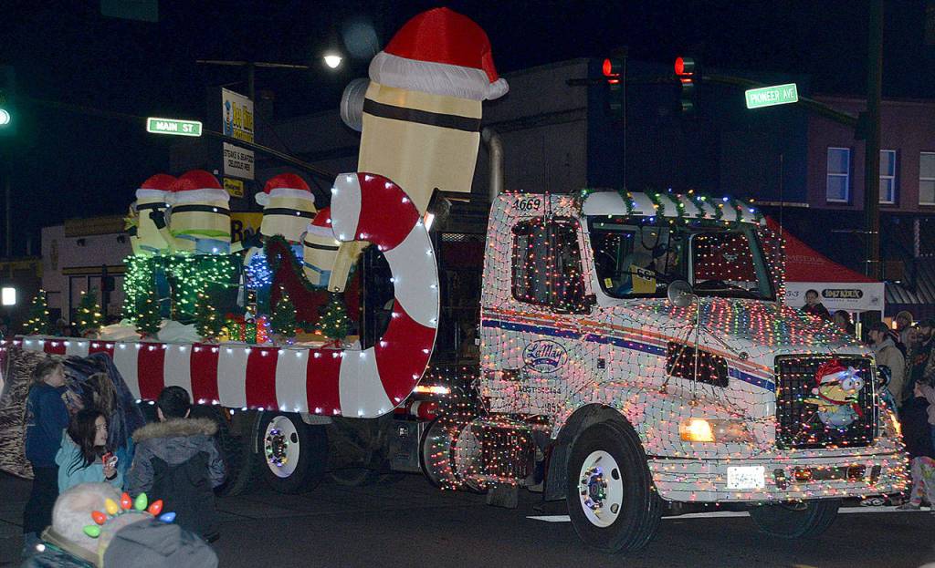 DAN HAMMOCK | GRAYS HARBOR NEWS GROUP                                The Minions hitch a ride with the LeMay entry in the 2018 Montesano Festival of Lights parade.