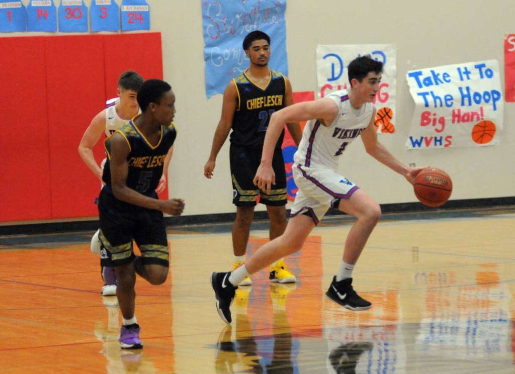 Willapa Valley sophomore Logan Walker dribbles up the court against the Chief Leschi Warriors on Saturday. (Ryan Sparks | Grays Harbor News Group)