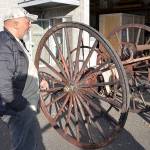 Louis Krauss | Grays Harbor News Group                                Aberdeen Museum of History director Dave Morris inspects the damaged wheels of another antique fire cart in Kent last week.