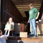 Photos by Michael Lang | Grays Harbor News Group                                Montesano High School junior Honour Iversen, from left, sophomore Cassadie Golding and senior Max Urbanski re-enact loading food for a photographer who missed the first loading Monday in Montesano.