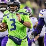 Seahawks quarterback Russell Wilson takes off on a 40-yard scramble against Vikings defensive tackle Linval Joseph, right, and defensive tackle Sheldon Richardson, left, as the Seattle Seahawks take on the Minnesota Vikings for at CenturyLink Field on Dec. 10, 2018 in Seattle. (Bettina Hansen/Seattle Times/TNS)