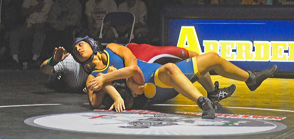 Aberdeens Ciera Skelly looks for a pin against Ocostas Ben Velesco in a match on Wednesday. (Hasani Grayson | Grays Harbor News Group)