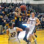 Aberdeens Javier Bojorge scores on a layup attempt while Payson Parker (22) attempts to draw a charge in the second quarter of the Bobcats 79-66 win on Friday. Bojorge scored 29 points to lead all scorers. (Hasani Grayson | Grays Harbor News Group)