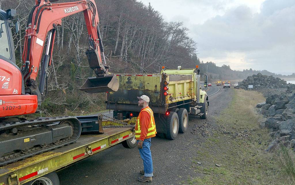 PHOTO COURTESY OF JOHN SHAW                                Crews with the State Department of Transportation stage Thursday morning on State Route 105 south of North Cove, where a section of the rock wall protecting the roadway was breached by Thursdays high winds and surf.