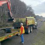 PHOTO COURTESY OF JOHN SHAW                                Crews with the State Department of Transportation stage Thursday morning on State Route 105 south of North Cove, where a section of the rock wall protecting the roadway was breached by Thursdays high winds and surf.