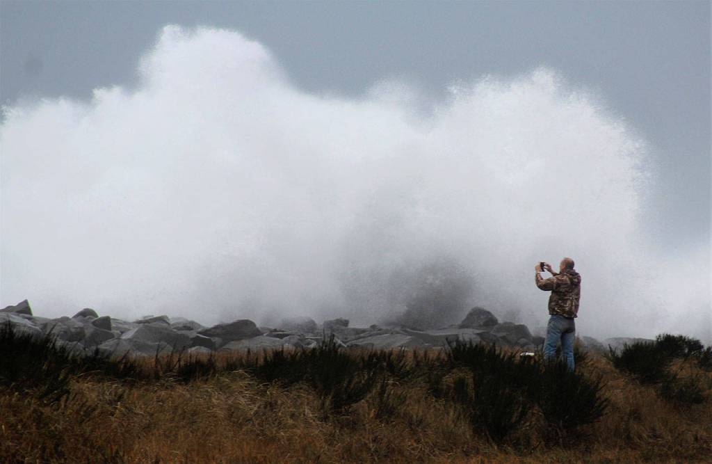 (Angelo Bruscas | Grays Harbor News Group) Someone takes picture of a wave crashing in Westport on Thursday.