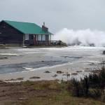 (Marcy Merrill) The sea reaches for the last house standing on the point at North Cove.