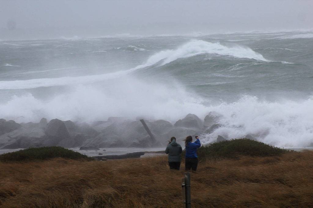 (Angelo Bruscas | Grays Harbor News Group) Visitors take pictures of waves crashing against the Westport Jetty.