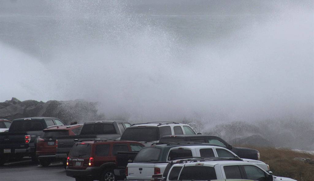 (Angelo Bruscas | Grays Harbor News Group) Cars lie beneath a crashing wave in Westport on Thursday.