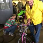Greg Johnstone, left, and Gene Schermer adjust the brakes on a bike thats ready to go.