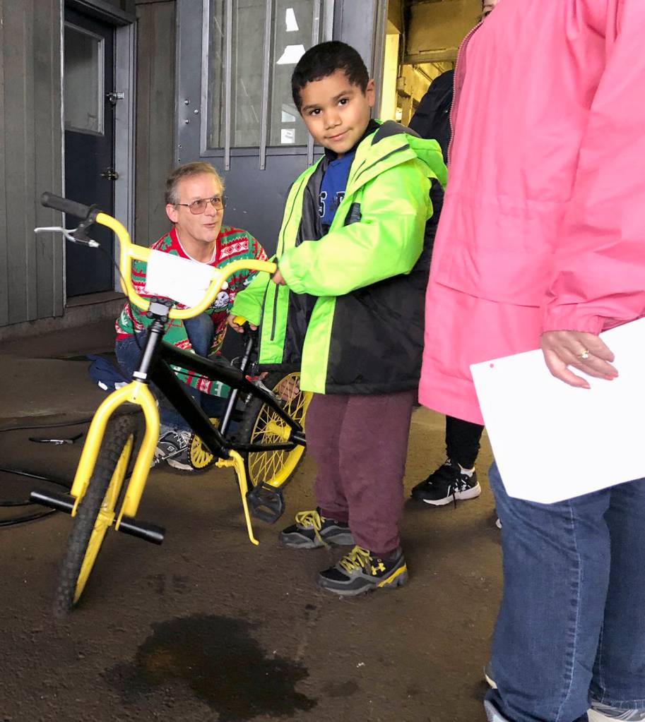 (Courtesy Bruce Worth, Aberdeen Lions Club) Greg Johnstone checks the pressure in the tires of a bike thats ready to go to a new home.
