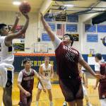 Aberdeens Javier Bojorge, left, shoots a jump shot while Hoquiams Matt Brown (42) defends during Thursdays game. (Hasani Grayson | Grays Harbor News Group)