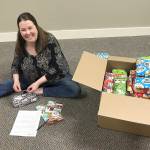 Courtesy Kyna Wilson                                Dawn Toney, a licensed mental health counselor at Olympia Therapy, prepares gifts for a drive led by Hands-On-Health Chiropractic.