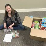 Courtesy Kyna Wilson                                Dawn Toney, a licensed mental health counselor at Olympia Therapy, prepares gifts for a drive led by Hands-On-Health Chiropractic.