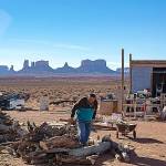 Jonah Yellowman looks over firewood, gathered from Cedar Mesa, at his home on the edge of Monument Valley, Utah. (Brian van der Brug/Los Angeles Times)