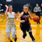 Raymonds Kyra Gardner, right, drives to the lane while defended by Ocostas Emily Snider on Friday. (Hasani Grayson | Grays Harbor News Group)