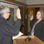 Michael Lang | Grays Harbor News Group                                Grays Harbor County Clerk Kym Foster (right) is sworn in to office Jan. 2 by Judge David Edwards in County Commission chambers in Montesano.