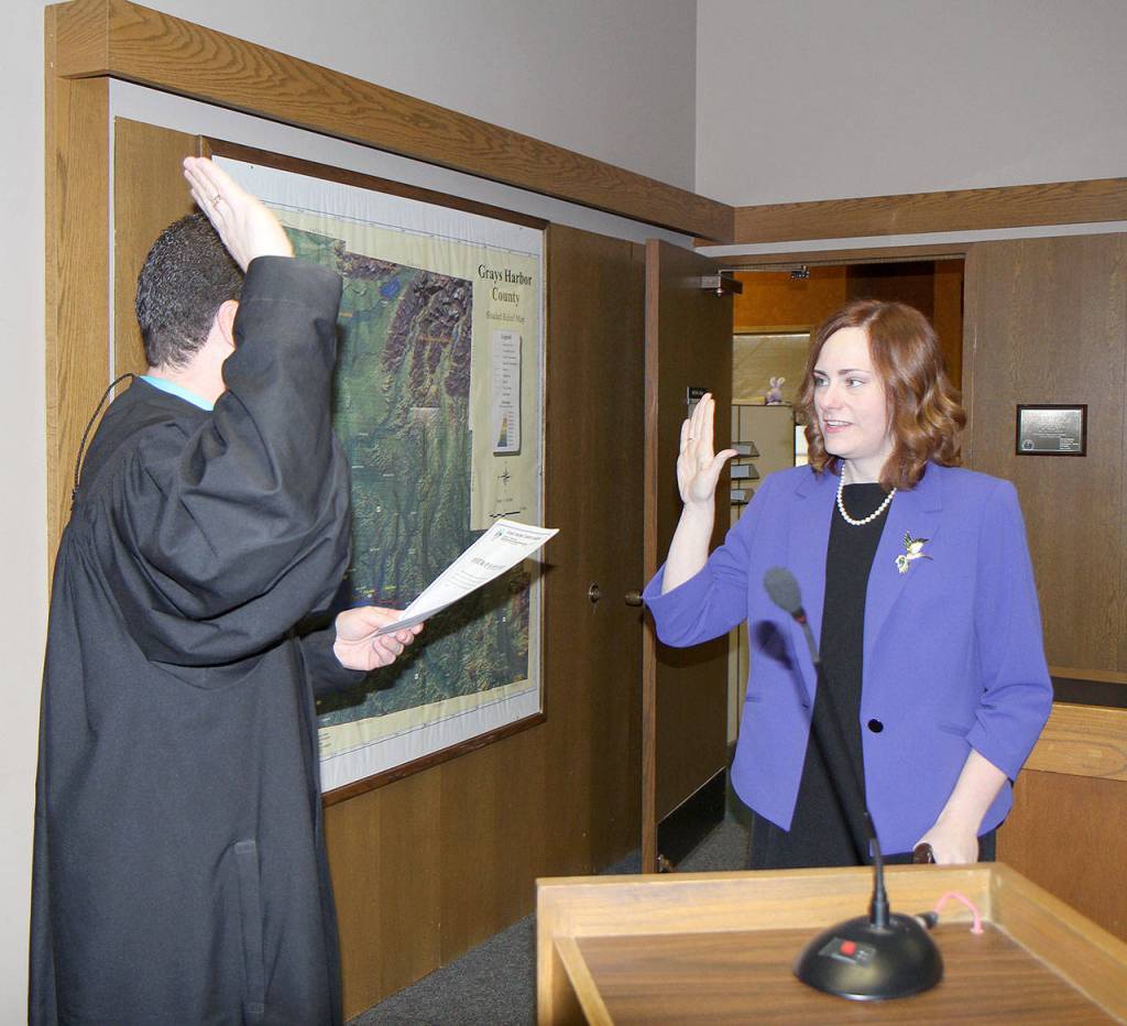 Michael Lang | Grays Harbor News Group                                  Grays Harbor County Prosecutor Katie Svoboda (right) is sworn in to office Jan. 2 by Judge David Mistachkin in County Commission chambers in Montesano.