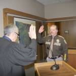 Michael Lang | Grays Harbor News Group                                Grays Harbor County Sheriff Rick Scott (right) is sworn in to office Jan. 2 by Judge David Edwards in County Commission chambers in Montesano.