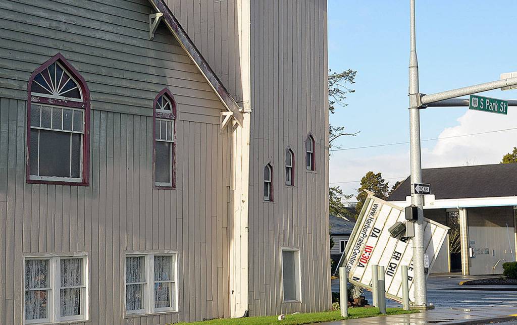DAN HAMMOCK | GRAYS HARBOR NEWS GROUP                                Strong winds knocked the sign off the Harbor Praise Center at the corner of West Wishkah and South Park streets in Aberdeen Sunday morning. Monday morning the traffic light at the intersection was still blinking and the crosswalk signals were disabled.
