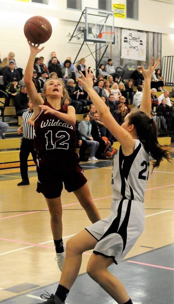 Ocostas Kjirstin Hopfer tries to hit a floater deep in the paint against Northwest Christian. (Hasani Grayson | Grays Harbor News Group)
