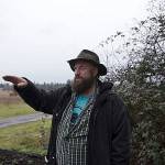 Deston Denniston, executive director of VETS_CAFE, stands on a donated 120-acre plot of land on Wednesday, Jan. 9, and discusses the layout of the land. (Cody Neuenschwander | The Chronicle)