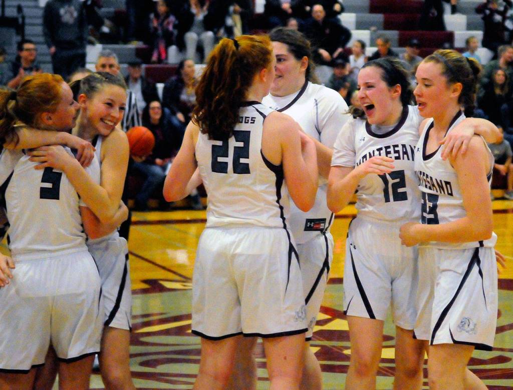 Montesano players celebrate at half court after the final buzzer in a 45-30 win over Elma on Tuesday. (Hasani Grayson | Grays Harbor News Group)