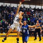 Montesanos Paige Lisherness finishes a break away layup in the second quarter while defended by Elmas Kaelyn Burgher in the second quarter. (Hasani Grayson | Grays Harbor News Group)