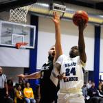 Grays Harbors Zyare Rffun (24) finishes a layup while defended by Highlines Ethan Gates in the first half on Wednesday. Ruffin led the Chokers with 20 points in Grays Harbors 80-60 loss. (Hasani Grayson | Grays Harbor News Group)