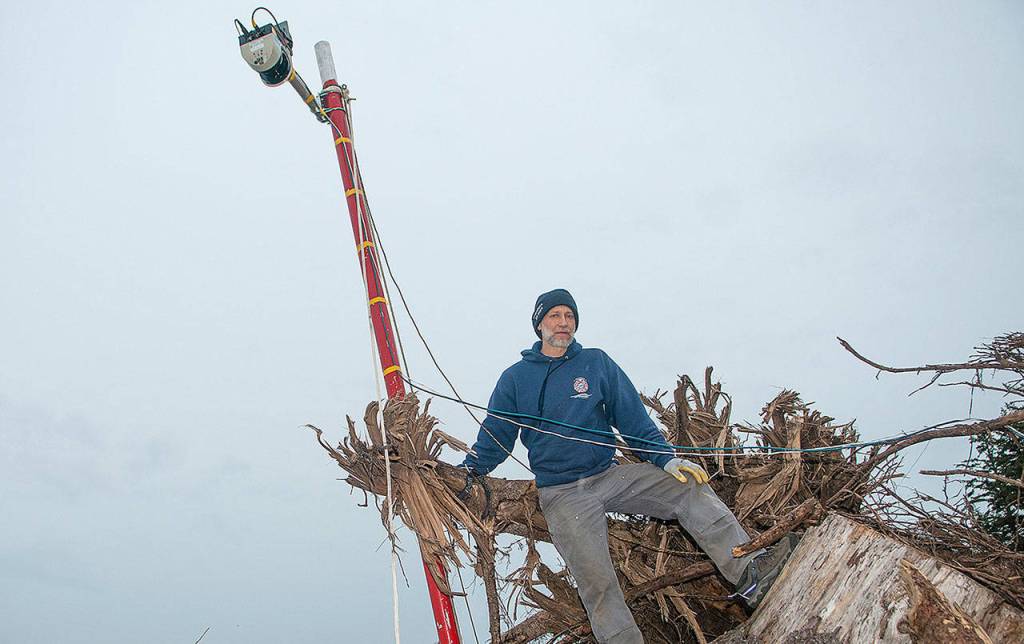 MARCY MERRILL PHOTO                                Department of Ecology coastal engineer George Kaminsky sets up a lidar tower on the North Cove shoreline Wednesday. The tower is part of research on the regions dynamic revetment shoreline preservation efforts by Paul Bayle from the University of Bath in England.