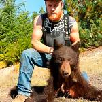 William Haynes poses with the carcass of a poached bear (Courtesy WDFW)