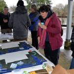 Louis Krauss | Grays Harbor News Group                                Ruth Garrett, in pink jacket, checks out a map of potential flooding scenarios in Grays Harbor and Pacific counties based on sea level rise in 2060 and 2100.
