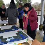 Louis Krauss | Grays Harbor News Group                                Ruth Garrett, in pink jacket, checks out a map of potential flooding scenarios in Grays Harbor and Pacific counties based on sea level rise in 2060 and 2100.