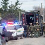 The State Patrol SWAT team gathers after serving a warrant Thursday morning that led to the arrest of a man suspected to be involved in the triple homicide discovered New Years Eve. (Jesse Major/Peninsula Daily News)
