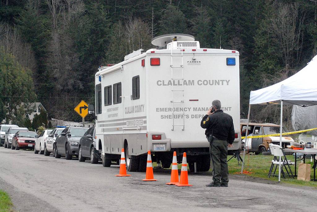 Chief Criminal Deputy Brian King talks on his phone outside an emergency command center set up on Lower Elwha Road west of Port Angeles on Thursday after a suspect was arrested in connection with a triple homicide last December. (Keith Thorpe/Peninsula Daily News)
