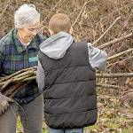 Jan Robinson of the Chehalis River Basin Land Trust works with a fourth-grade student from Montesano during a tree-planting event last week at the Discovery Trail in Centralia. (Will Rubin | The Chronicle)