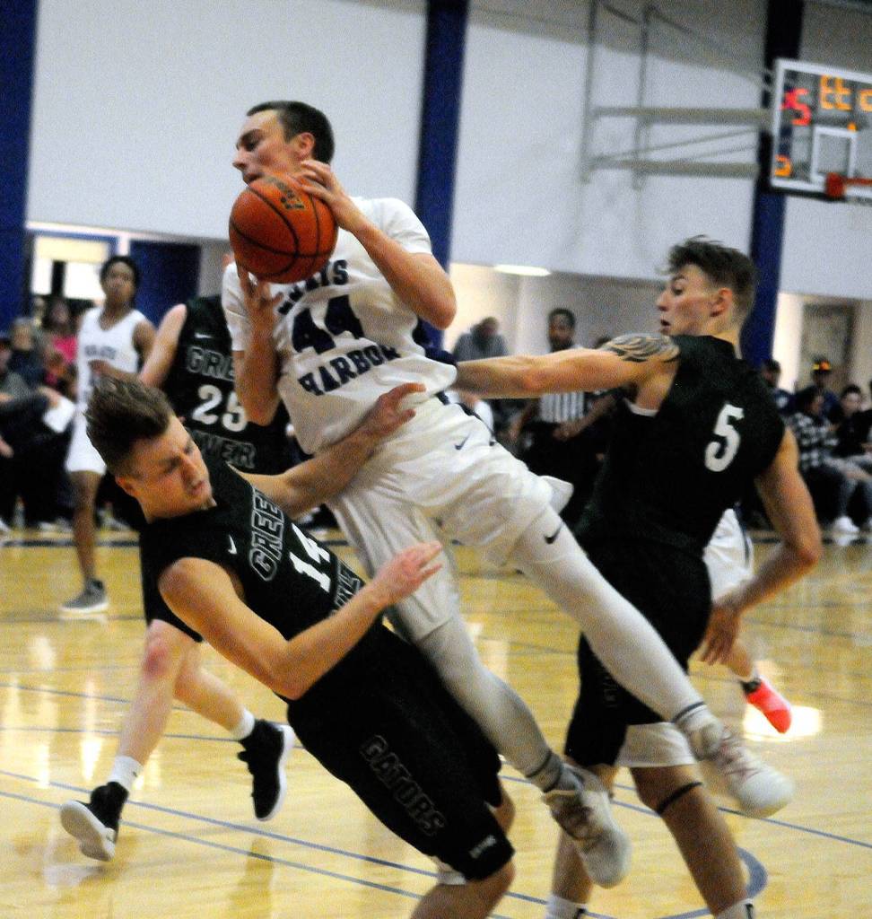Green Rivers Cam Cawley draws a charge against Grays Harbors Cody Brimhall in the first half. (Hasani Grayson | Grays Harbor News Group)
