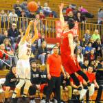 Hoquiams Jonny Smith, left, takes a 3-pointer in the second quarter against Tenino on Tuesday. (Hasani Grayson | Grays Harbor News Group)