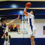 Grays Harbors Dallin Spencer hits a 3-point shot in the second half while Centralias Michael Brown, 4, comes in to defend. (Hasani Grayson | Grays Harbor News Group)