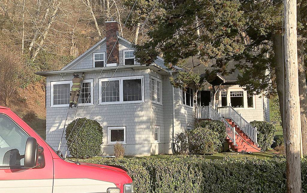 DAN HAMMOCK | GRAYS HARBOR NEWS GROUP                                A firefighter checks for hot spots after crews from Hoquiam and Aberdeen knocked down a fire at a residence at 23rd Street and Queets Avenue Thursday morning.