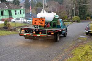 Louis Krauss | Grays Harbor News Group                                A truck for the City of Aberdeen lays down de-icing mixture onto Forsythe Street in North Aberdeen, in preparation for Friday nights snowfall. The mixture contains salt, water and sugar, which helps it stick.